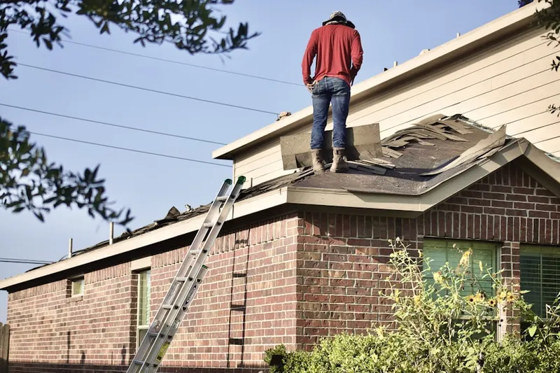 Professional roofer working on a residential roof in The Canyon
